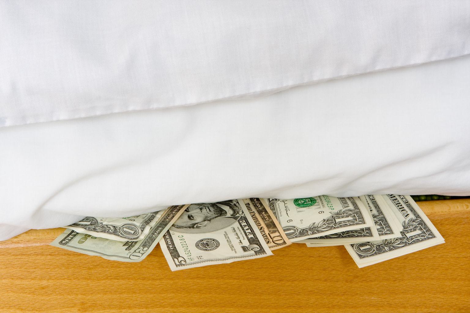 Money hidden under a white mattress