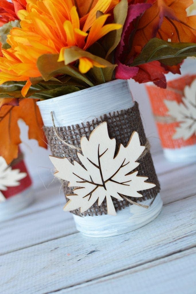 These Fall tin can centerpieces are an easy upcycle project that add a warm touch to your family's dinner table. Perfect for Thanksgiving too! #DIYFallCraft #FallCenterpieces