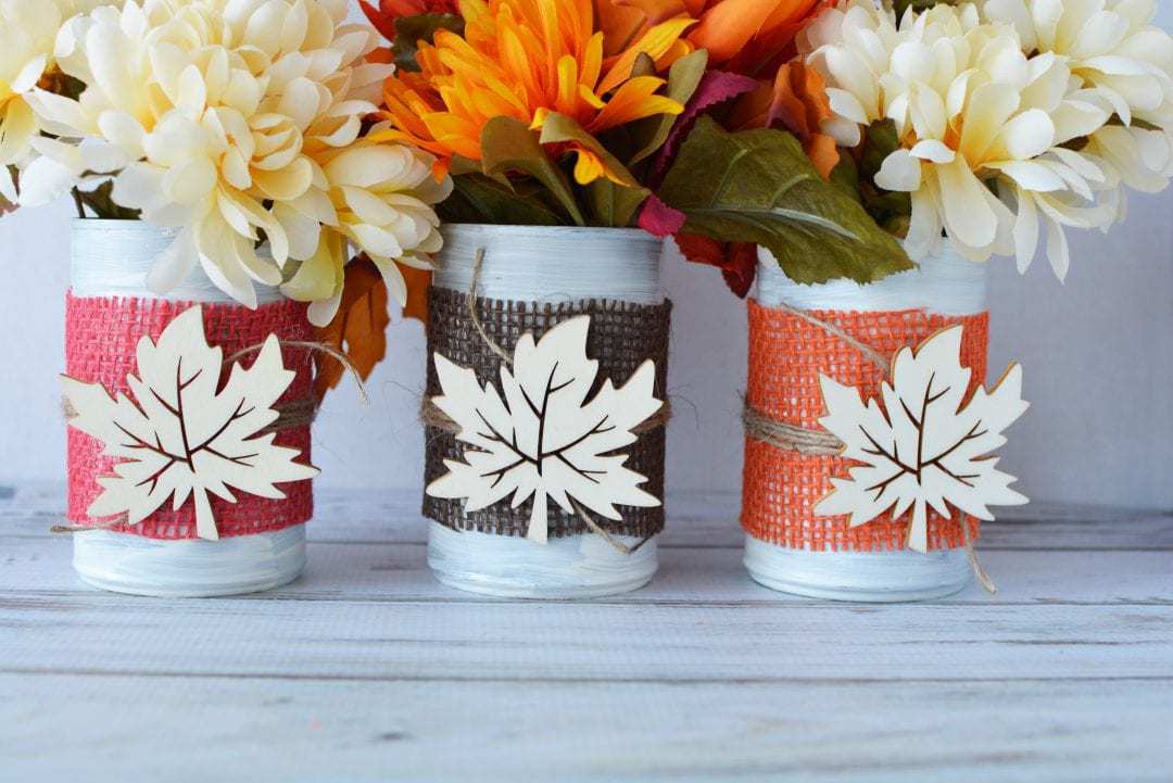 These Fall tin can centerpieces are an easy upcycle project that add a warm touch to your family's dinner table. Perfect for Thanksgiving too! #DIYFallCraft #FallCenterpieces