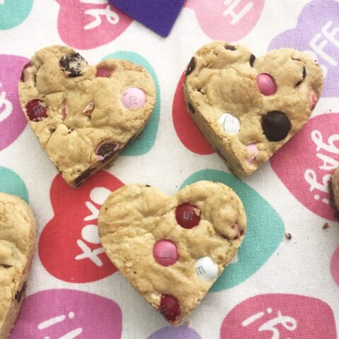 These Chocolate Chip Heart Shaped Cookie Bars are the one Valentine Day treat that you just can't miss! Made with Valentine's M&M's. They are simple to make and full of love! #HeartShapedCookies #CookieBars #ValentinesDayRecipes