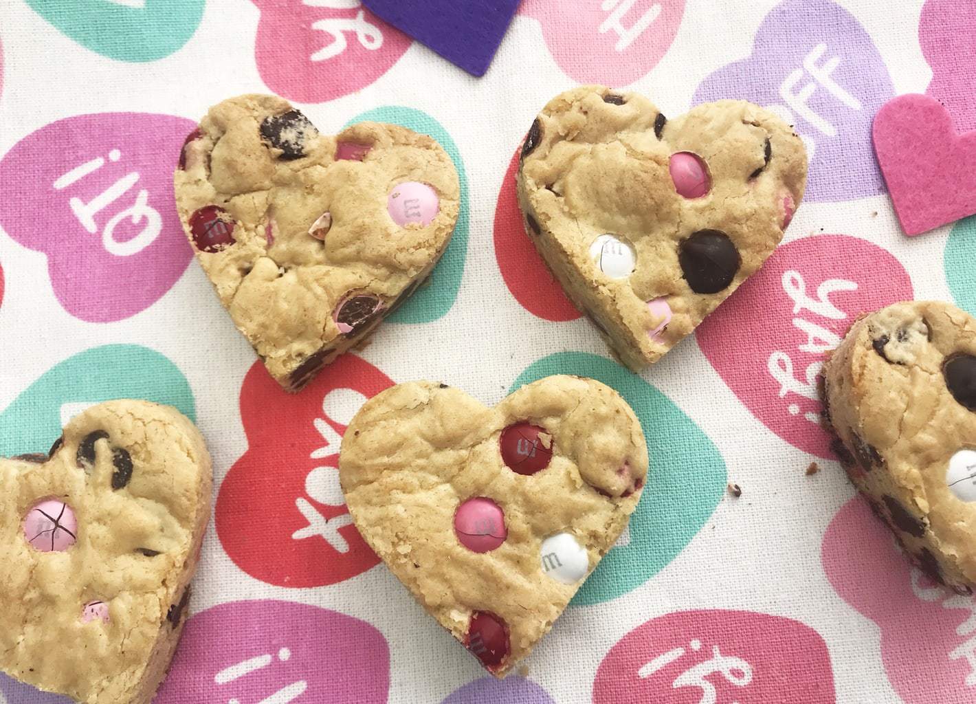 These Chocolate Chip Heart Shaped Cookie Bars are the one Valentine Day treat that you just can't miss! Made with Valentine's M&M's. They are simple to make and full of love! #HeartShapedCookies #CookieBars #ValentinesDayRecipes