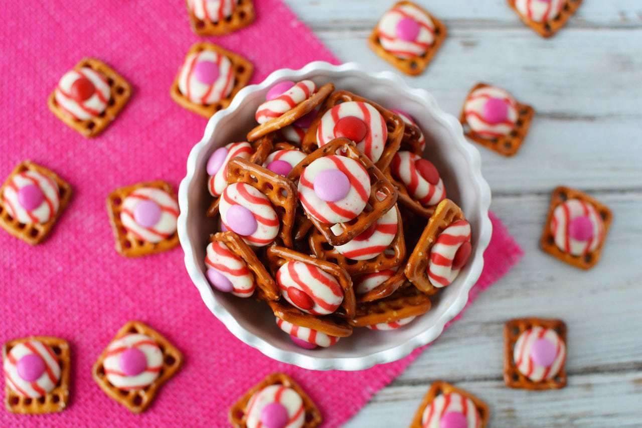Who doesn't love the texture of crispy and sweet? These M&M Peppermint Pretzel Kisses are a delicious treat to make and share with the ones that you love! #pretzelbites #peppermintkisses #valentinestreat