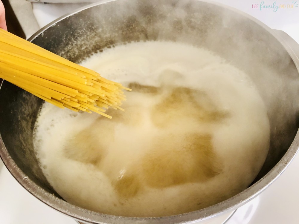 putting noodles into boiling water