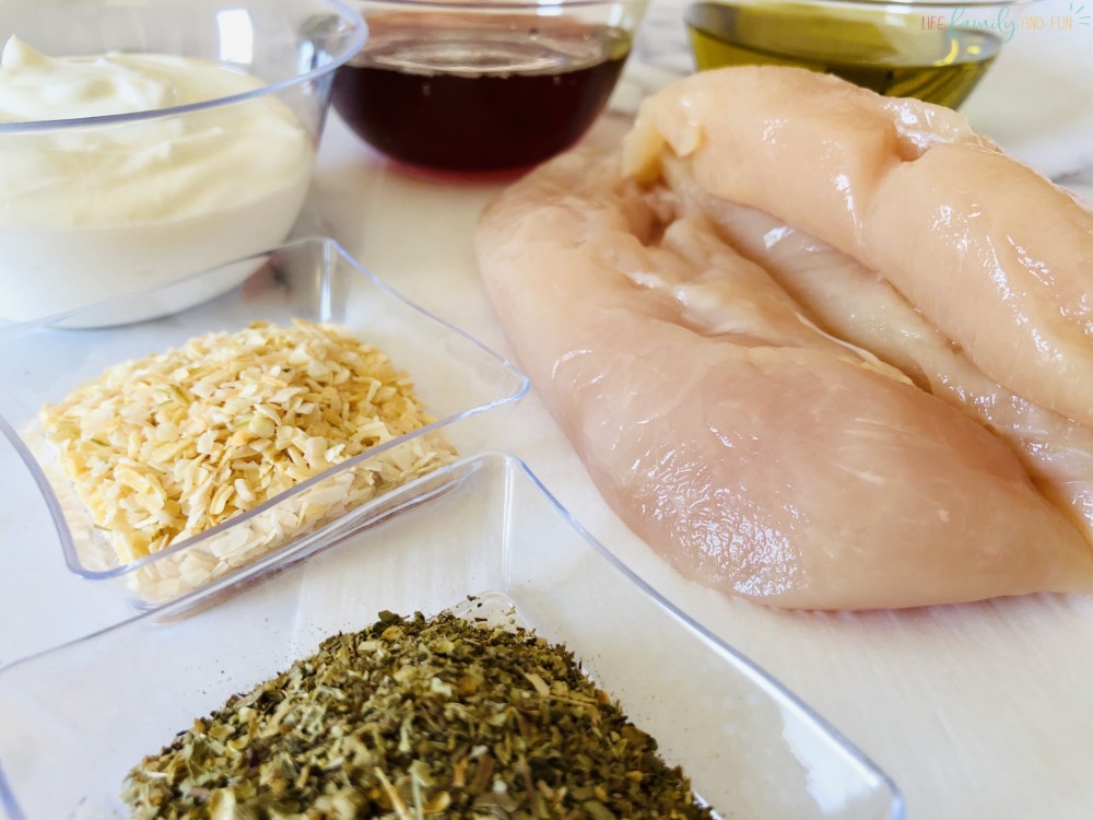 raw chicken and seasonings in small glass containers