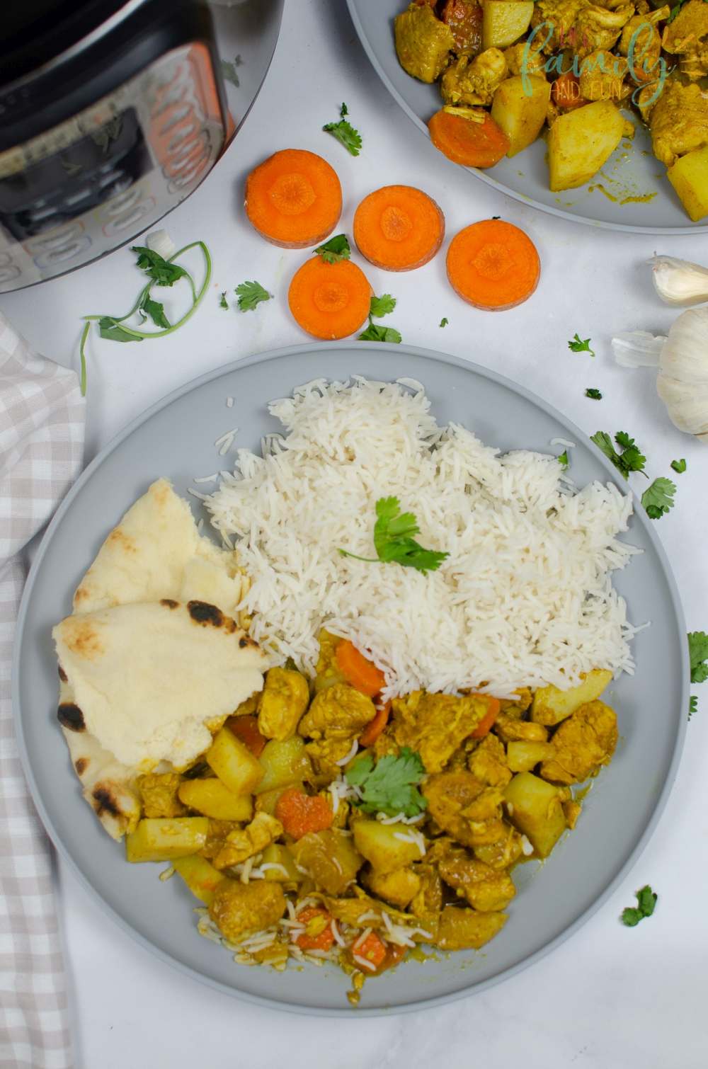 chicken curry with white rice and bread on plate
