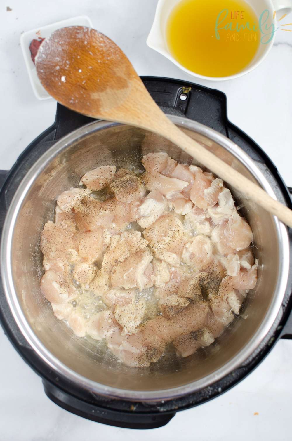chicken pieces cooking with salt and pepper in instant pot