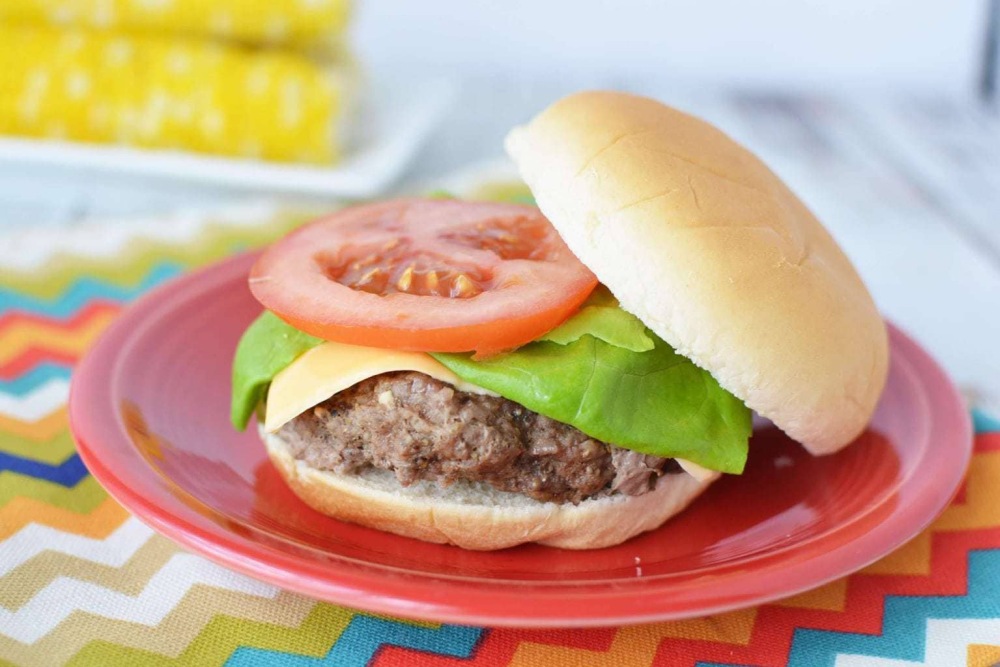 instant pot hamburgers with cheese lettuce and tomato on red plate