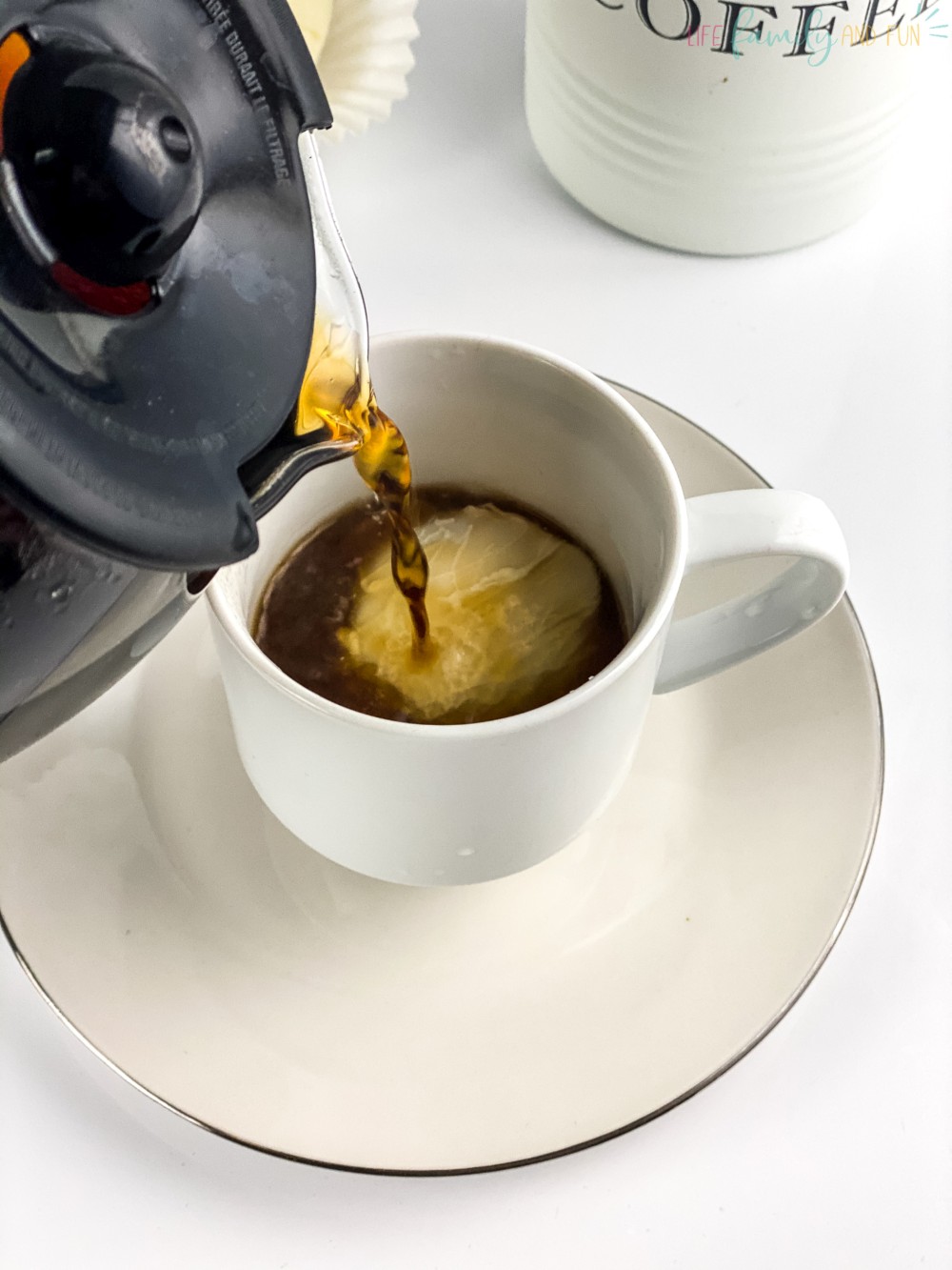 pouring coffee onto coffee bomb in mug
