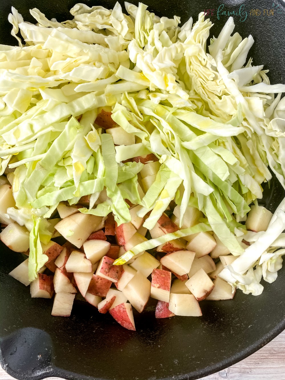 shredded cabbage and diced potatoes in skillet