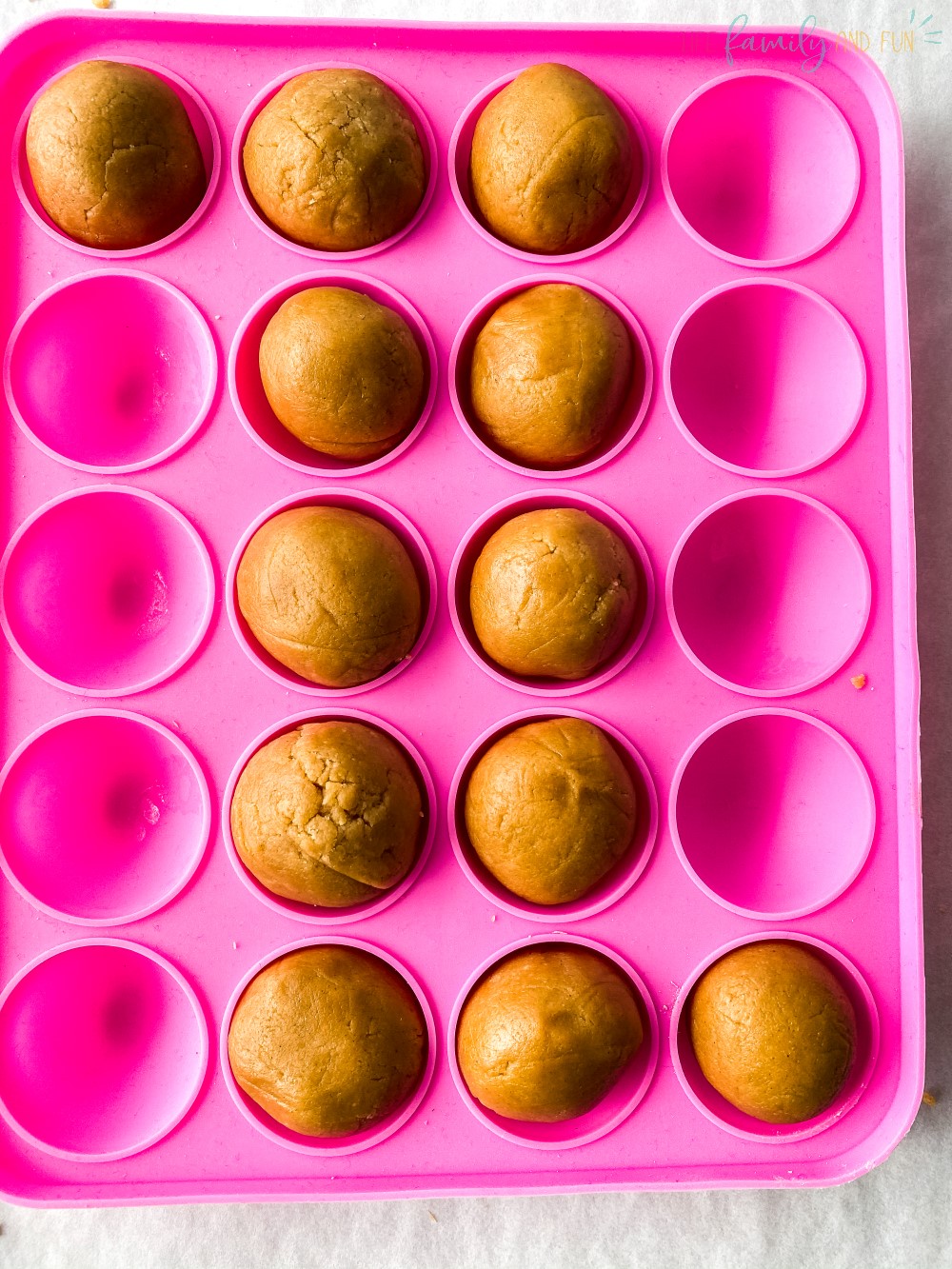 pink mold tray with peanut butter balls