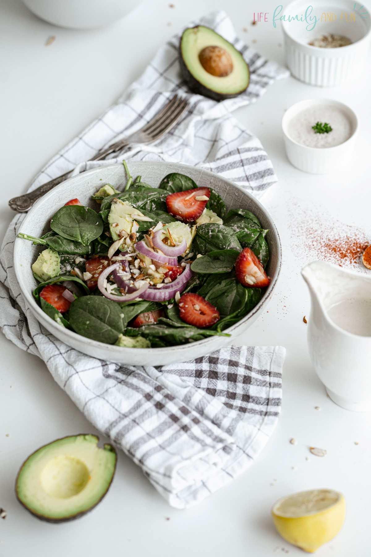 strawberry spinach salad in white bowl