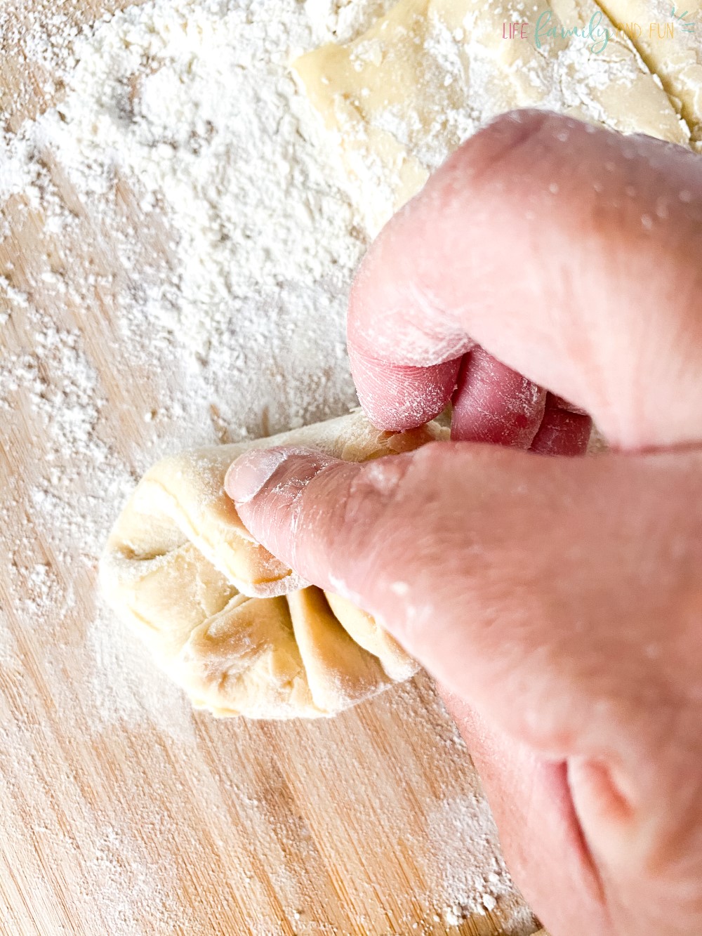 folding dough into balls with flour